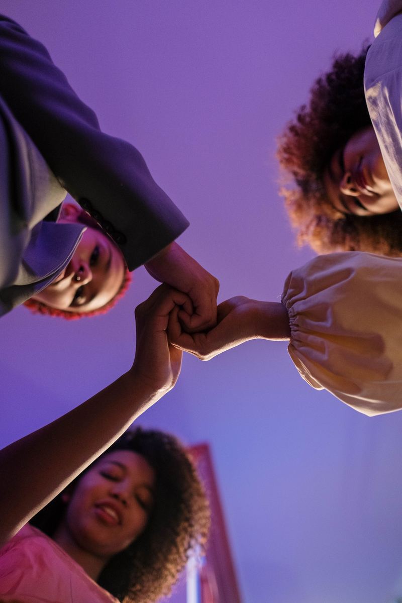 A group of women's hands joined together